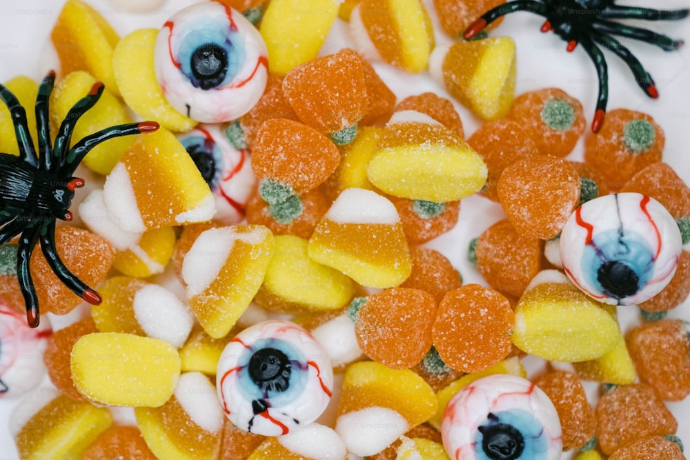 a close up of candy with eyes and candy candies