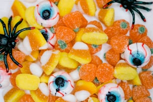 a close up of candy with eyes and candy candies