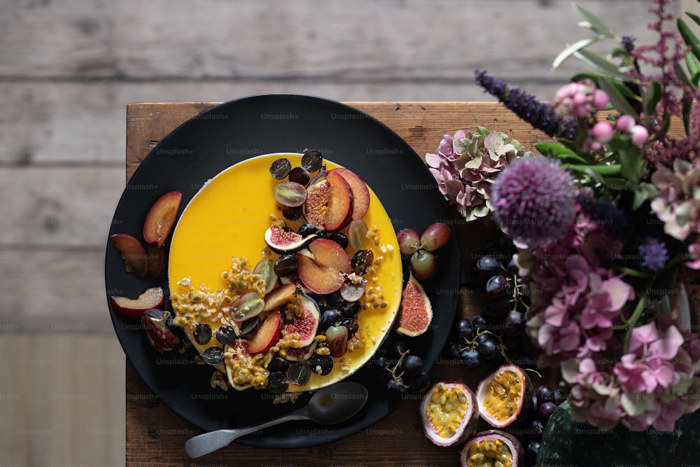 a black plate topped with fruit and cereal