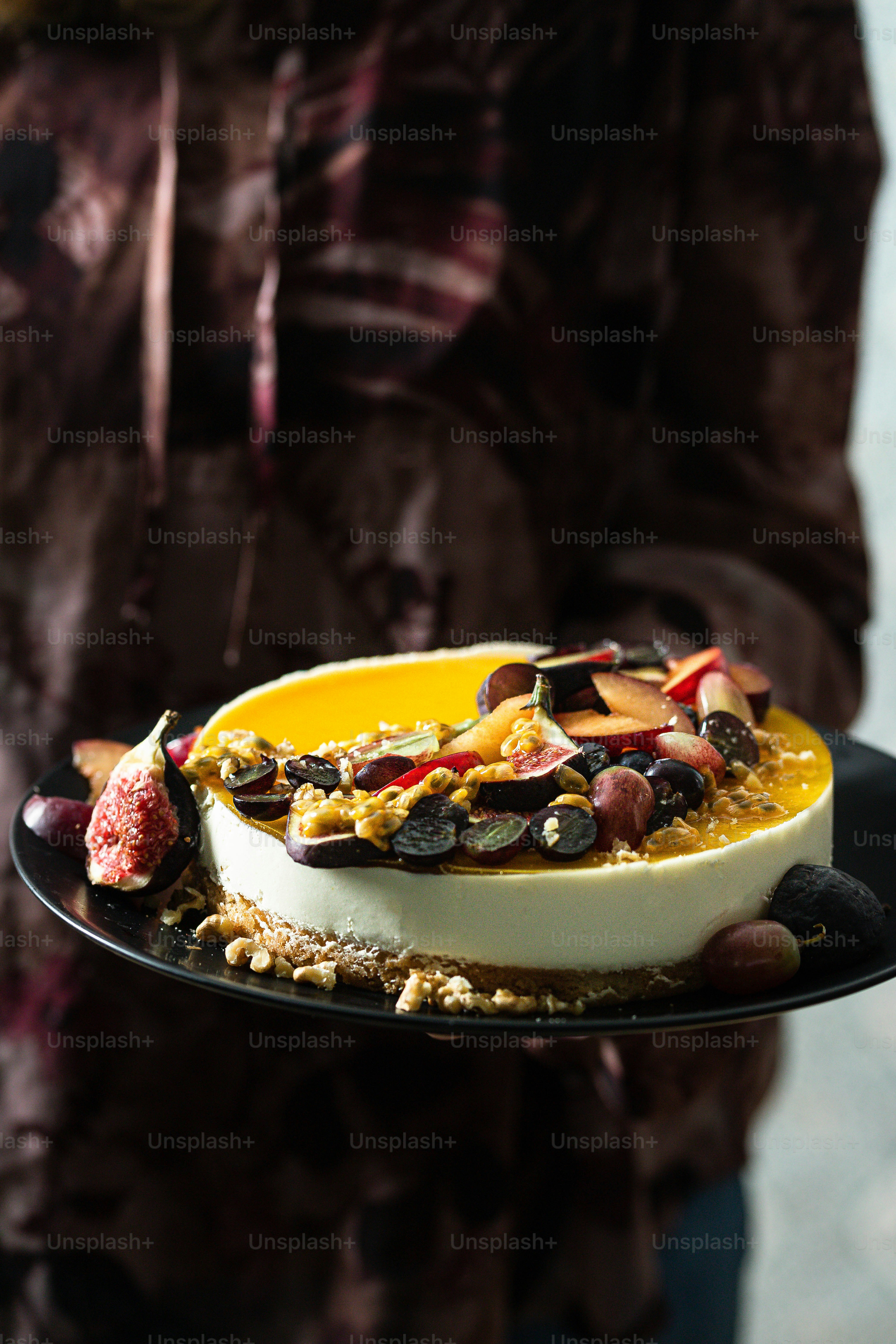 a person holding a plate with a dessert on it