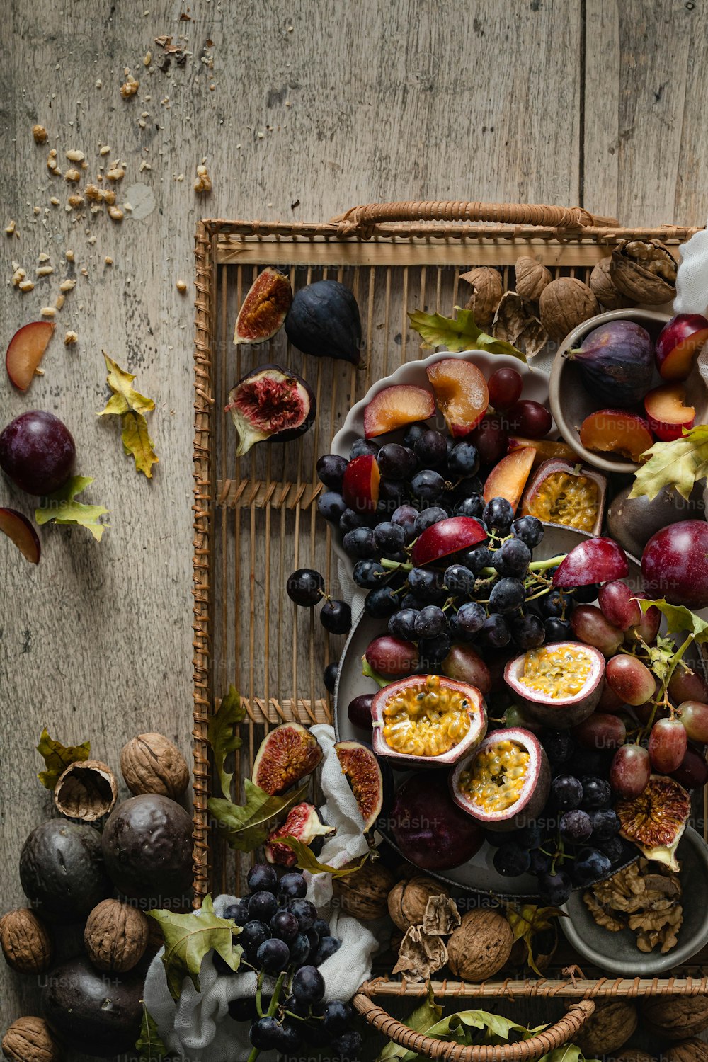 a tray filled with assorted fruits on top of a wooden table