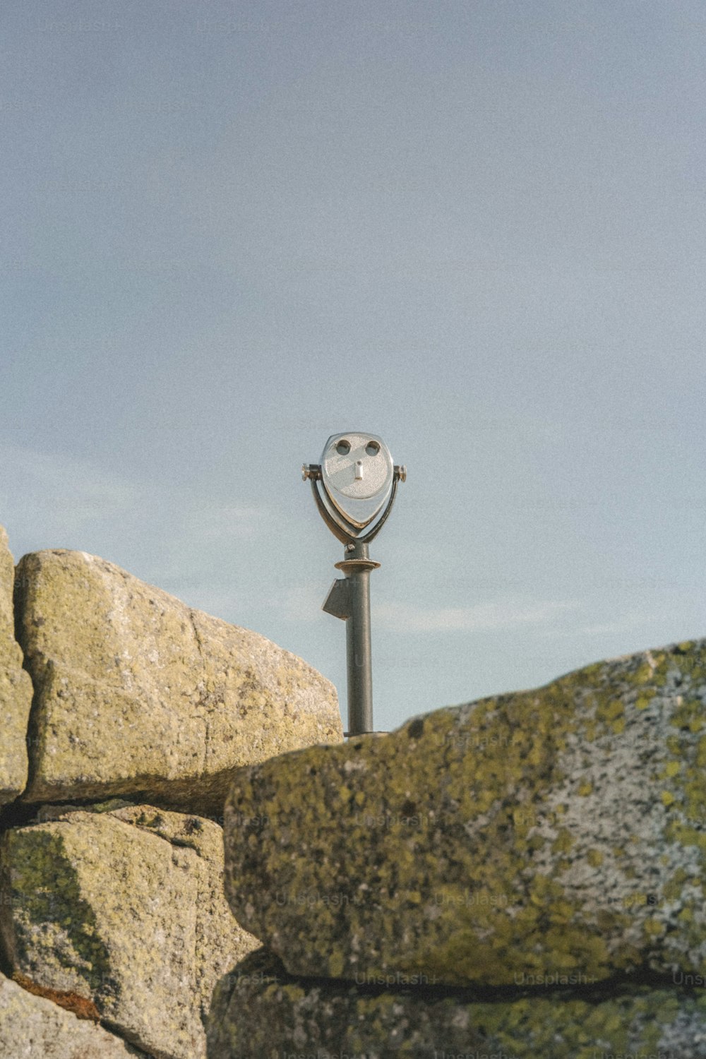 a street light sitting on top of a stone wall