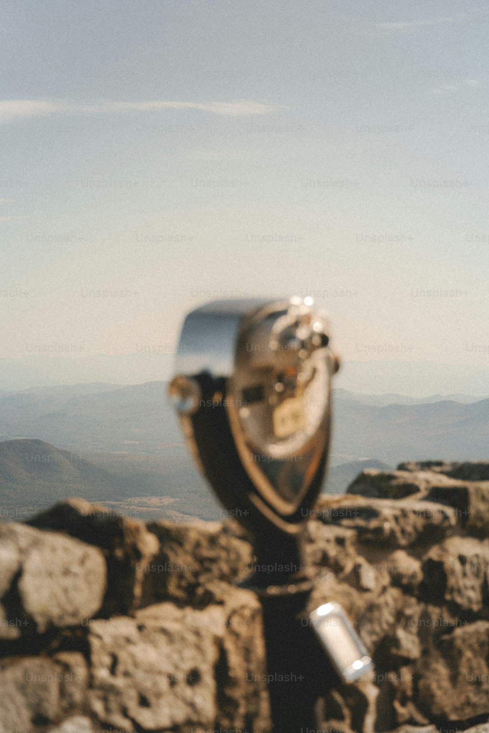 a close up of a metal object on a rock wall