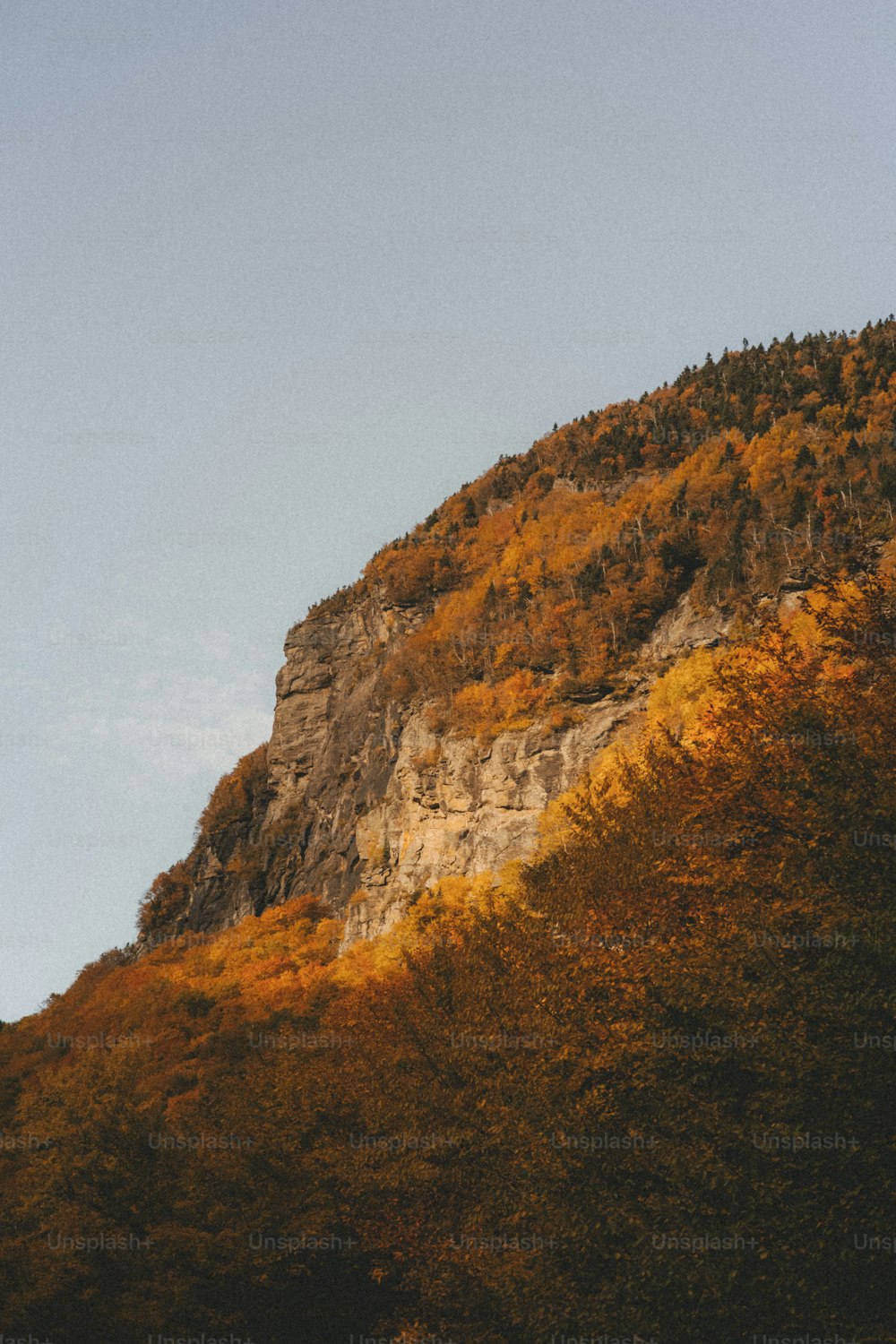 a plane flying over the top of a mountain