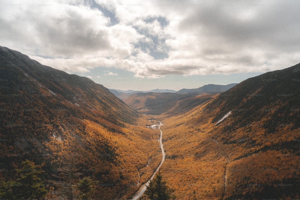 a scenic view of a winding road in the mountains