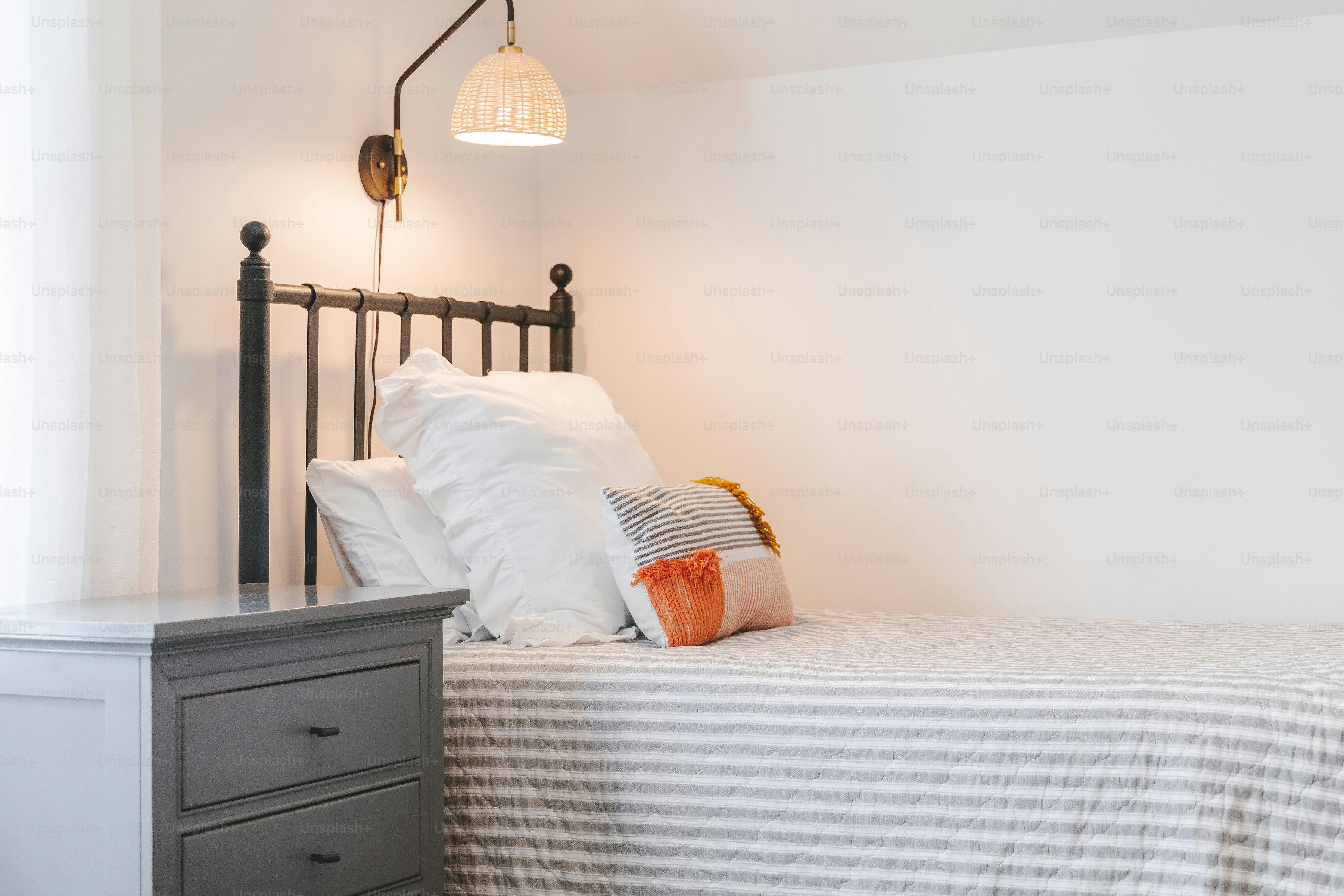 a bedroom with a bed, night stand, and nightstand