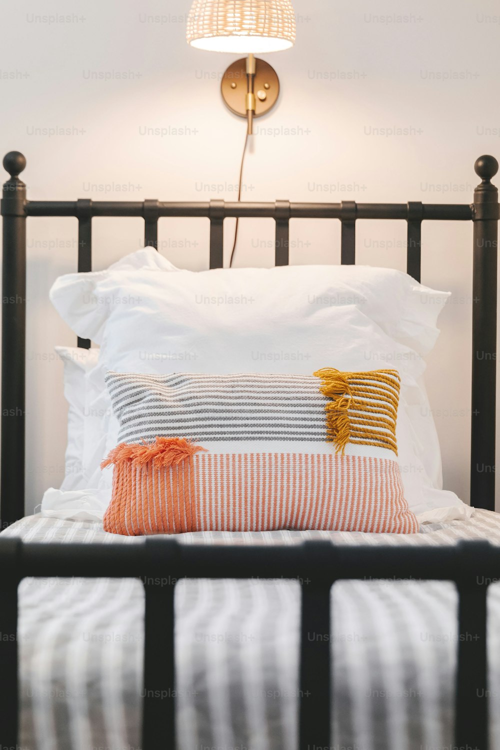 ein Bett mit zwei Kissen und einer Lampe