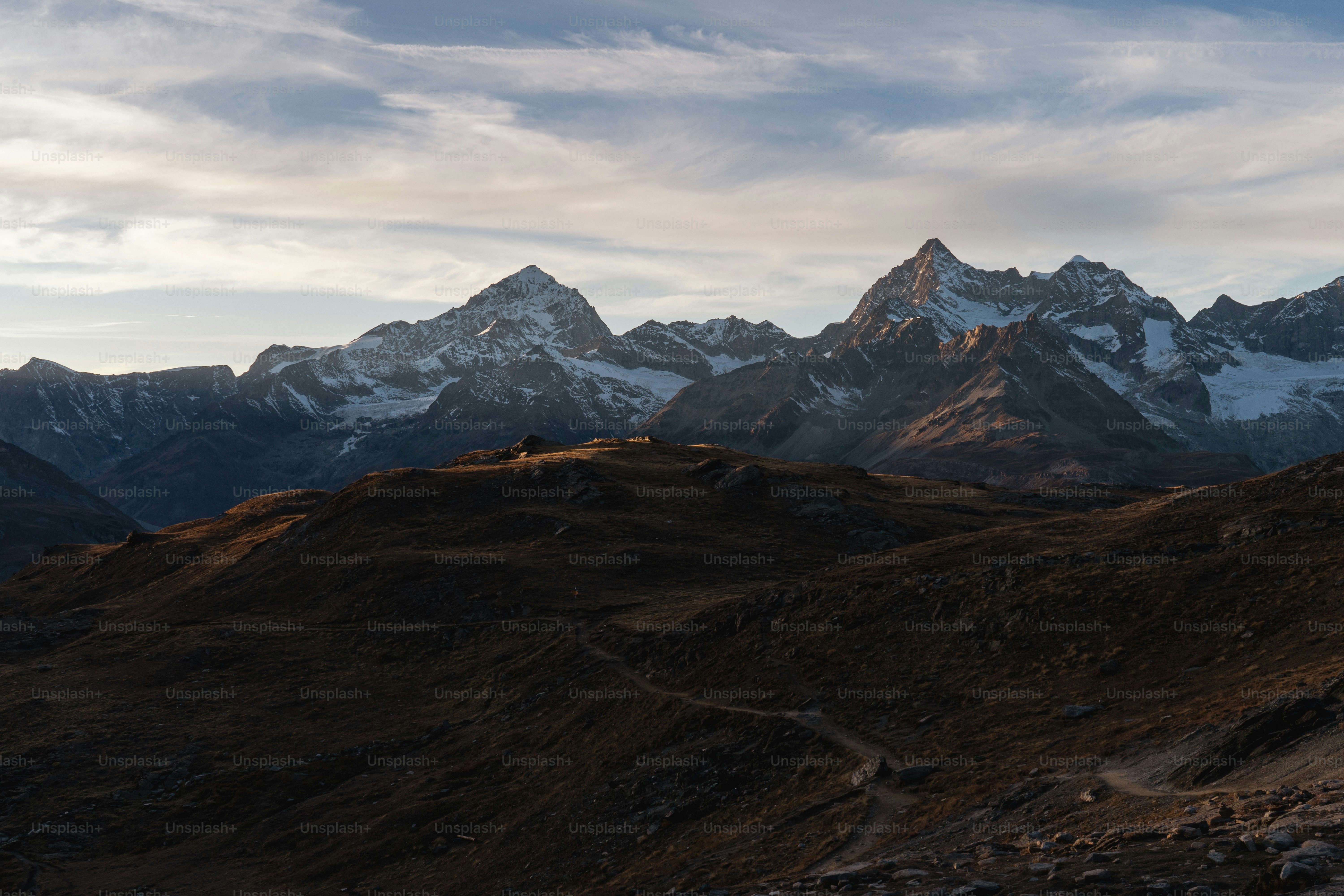 a view of a mountain range with a trail going through it