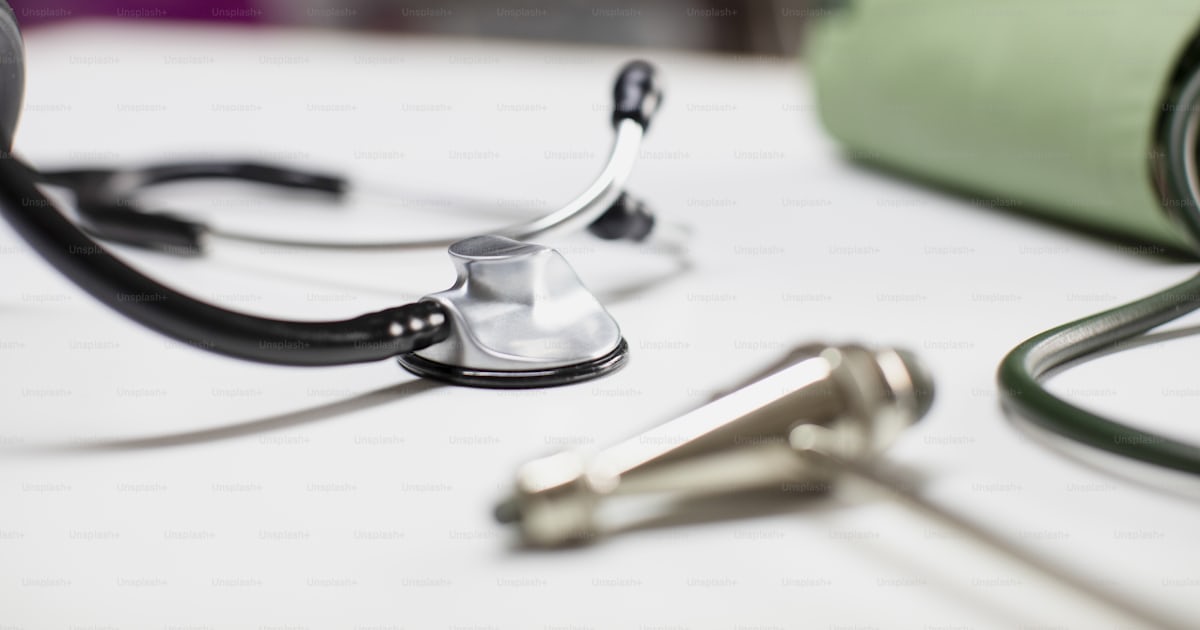 A close up of a stethoscope on a table photo – Sthetoscope Image on ...