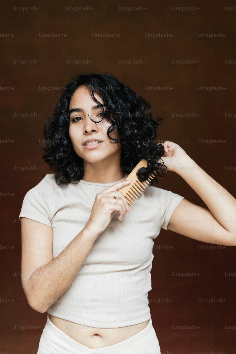 a woman holding a hair brush in her right hand