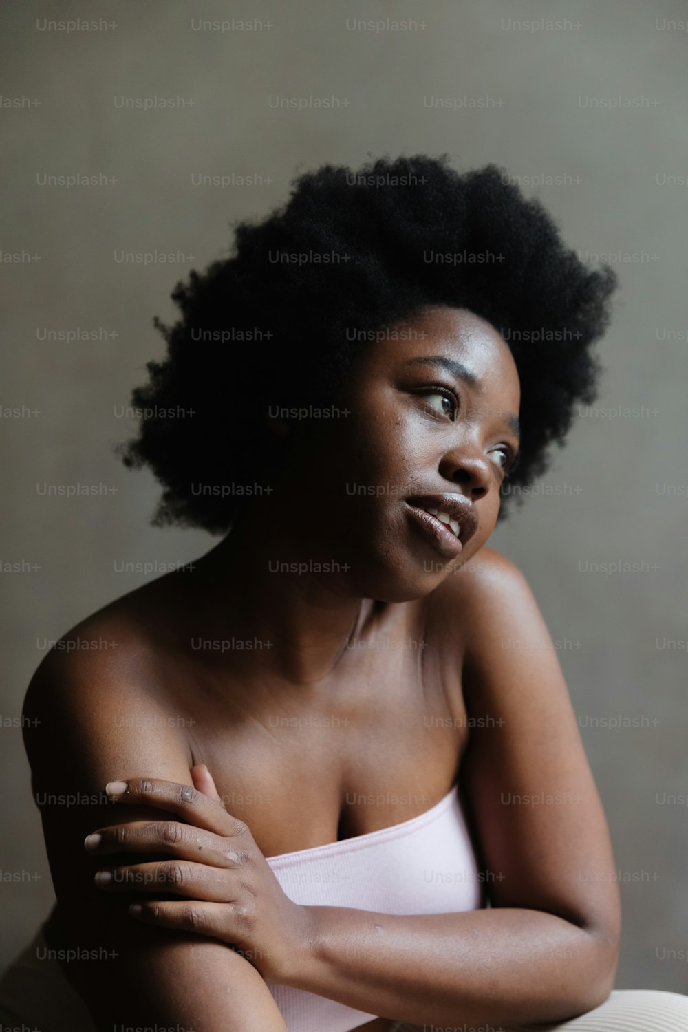 a woman with an afro sitting on a chair