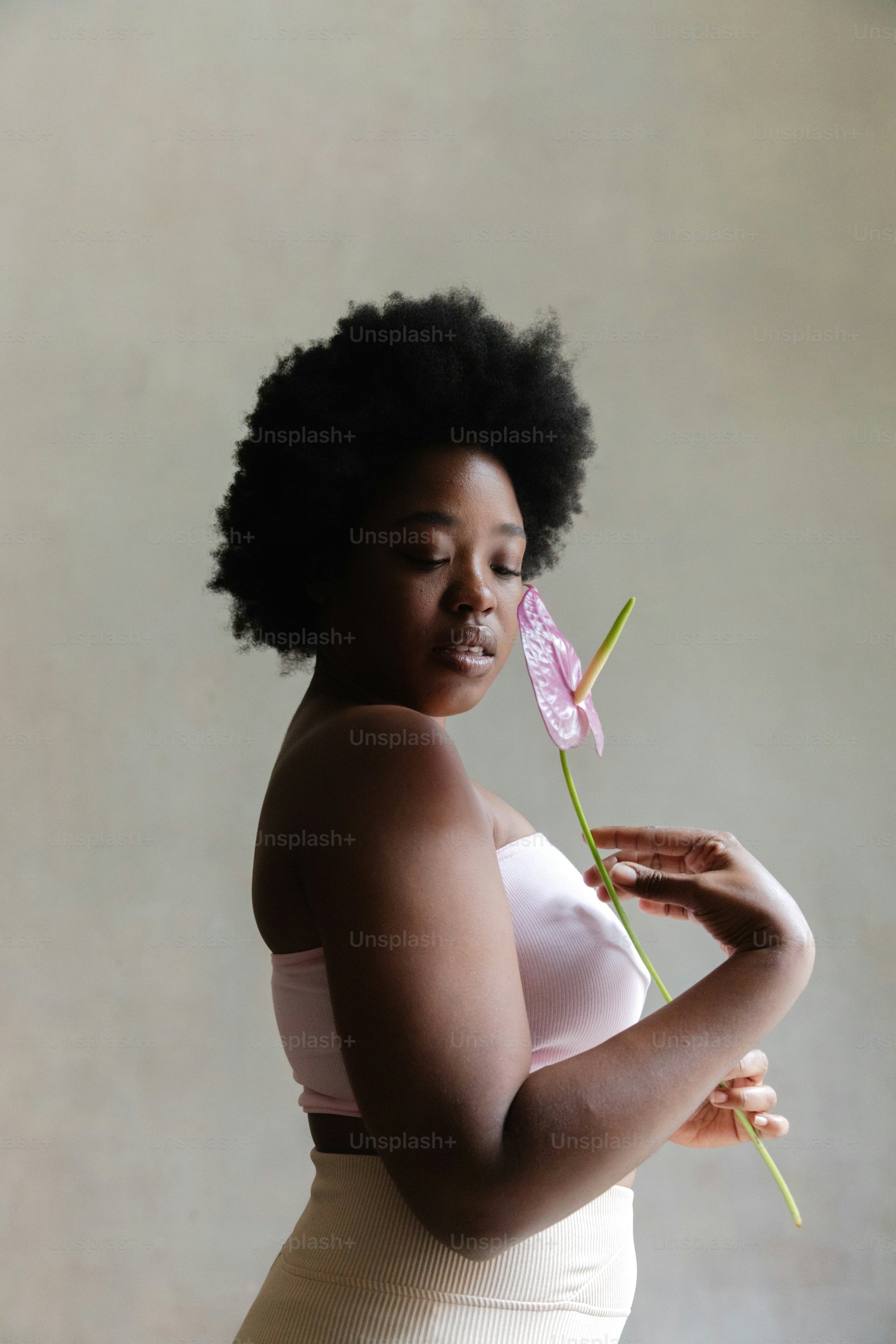 a woman holding a flower in her hand