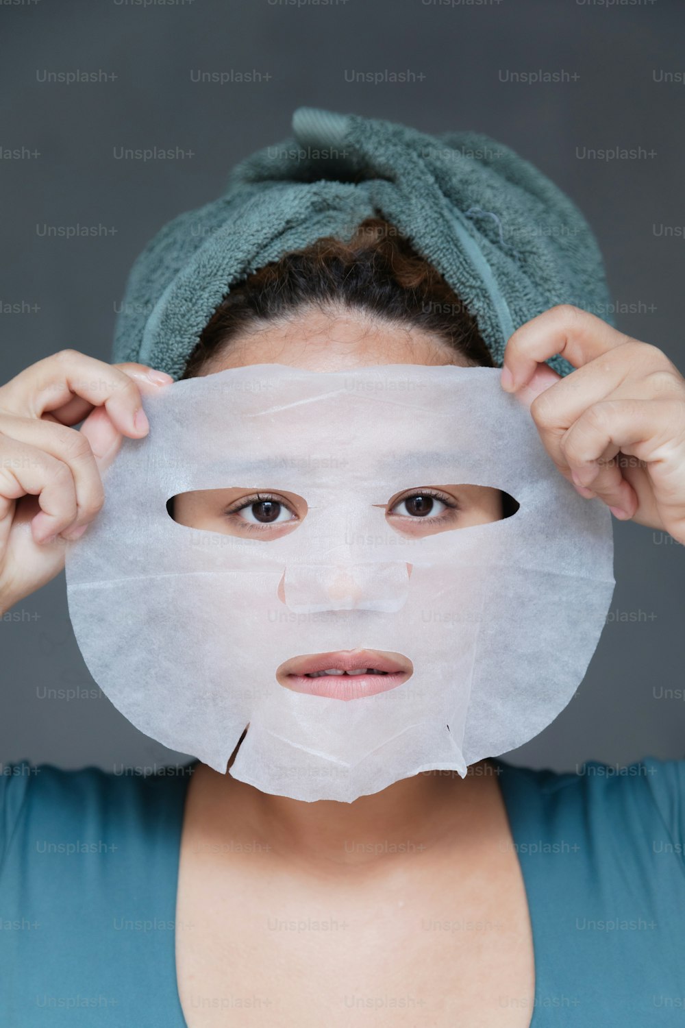a woman with a sheet of paper covering her face