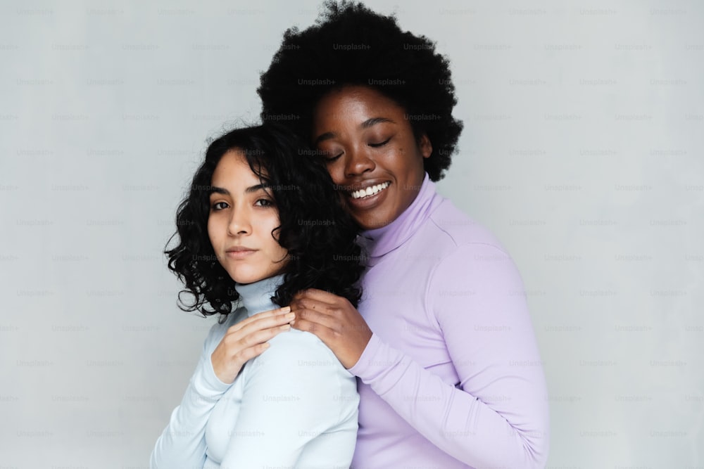 two women hugging each other and smiling