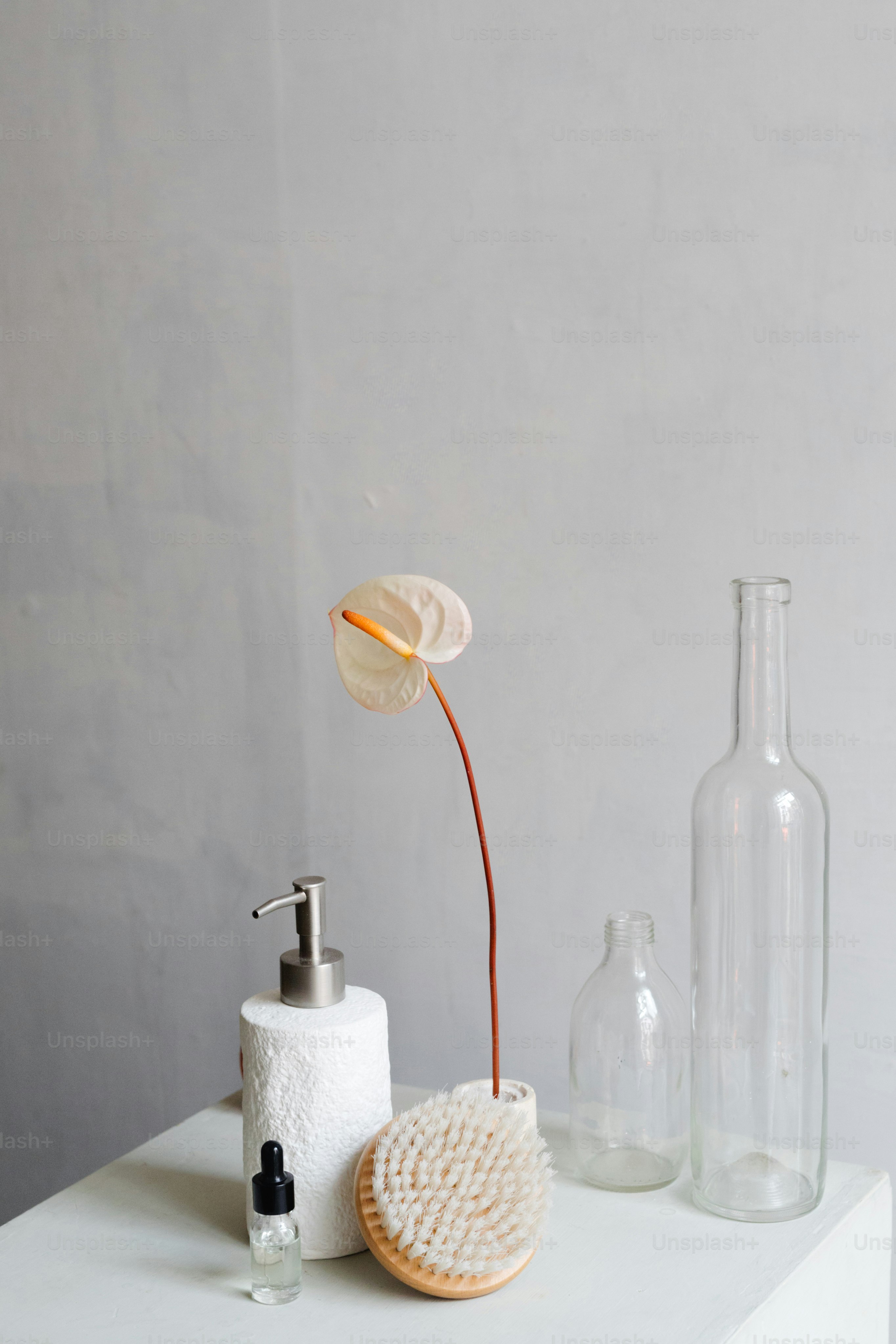 a soap dispenser, a soap dish, and a bottle on a