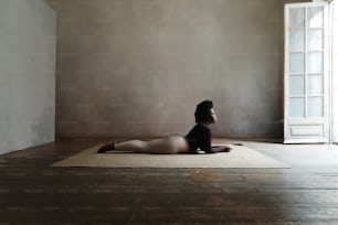 a woman sitting on a rug in a room