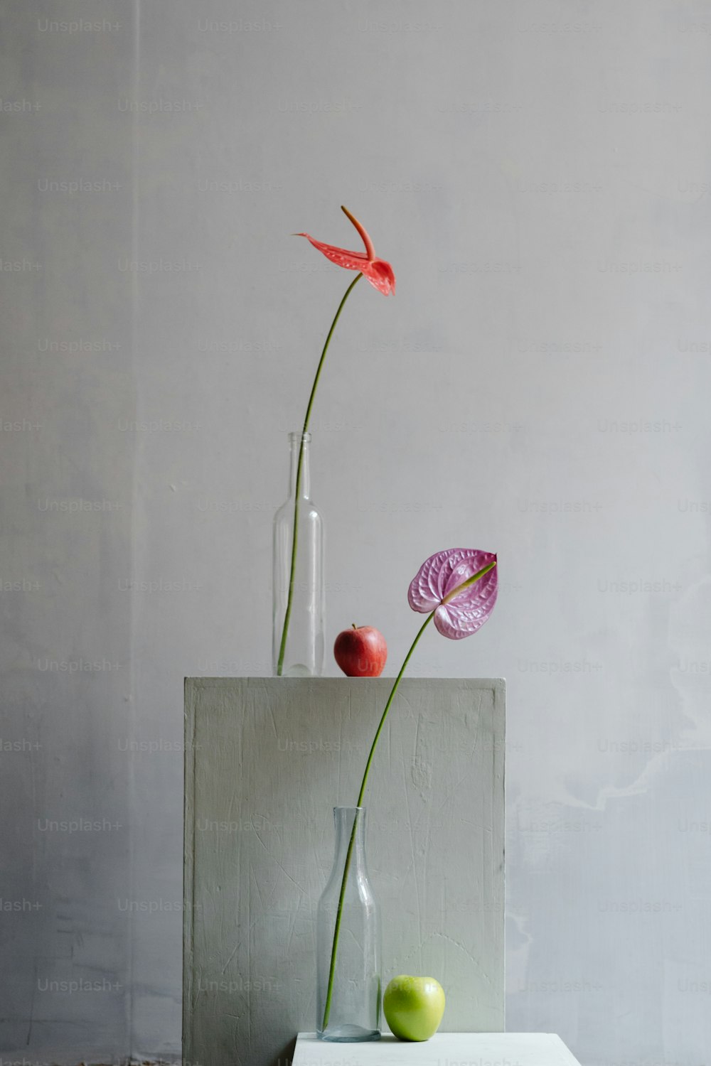 a vase with two flowers in it sitting on a table