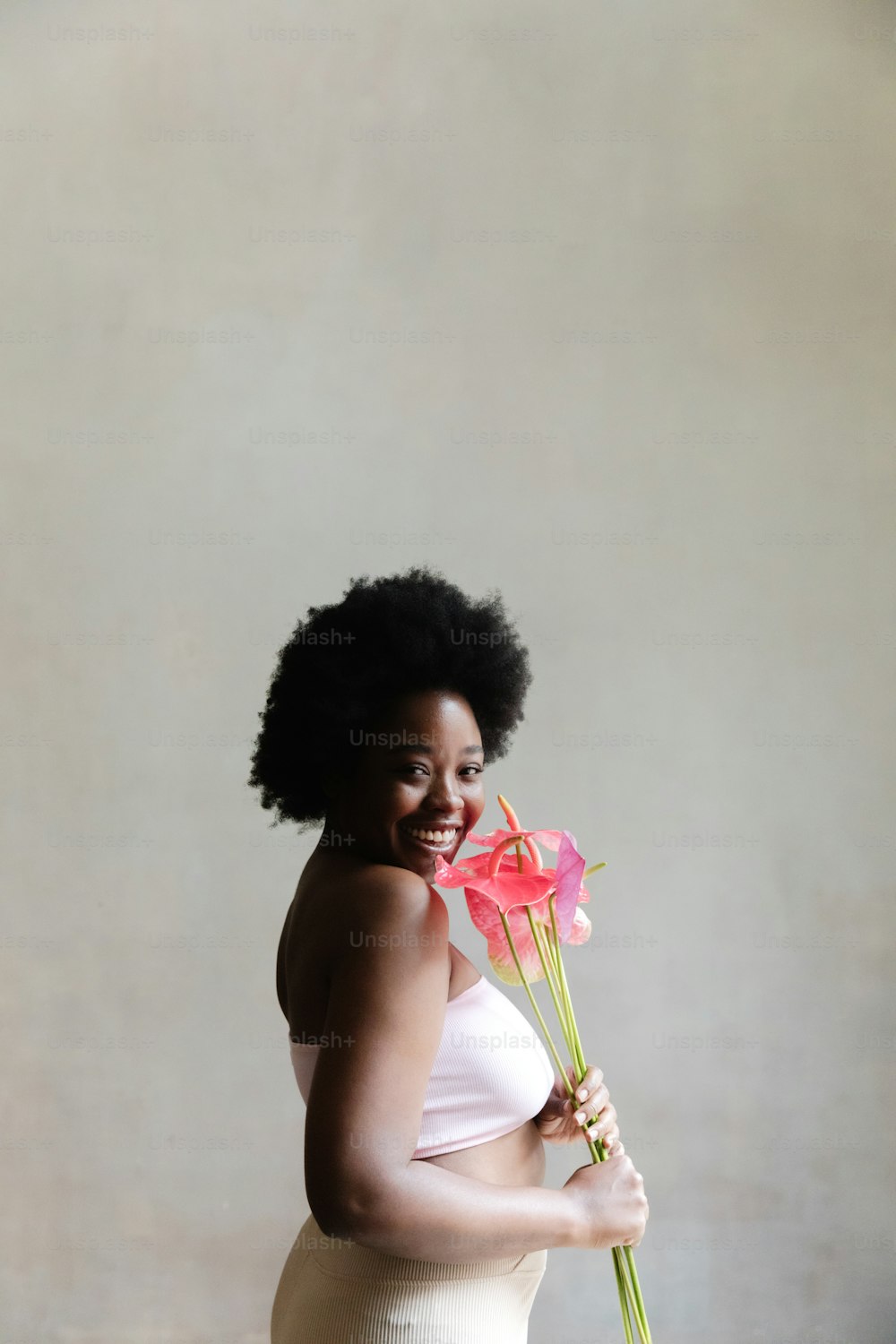 a woman holding a flower in her right hand