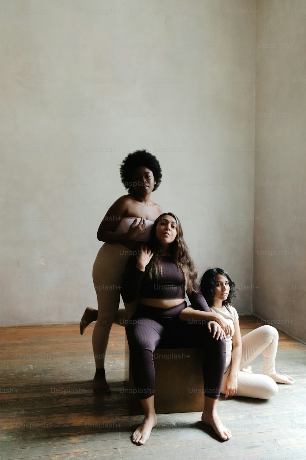 a group of women sitting on top of a wooden bench