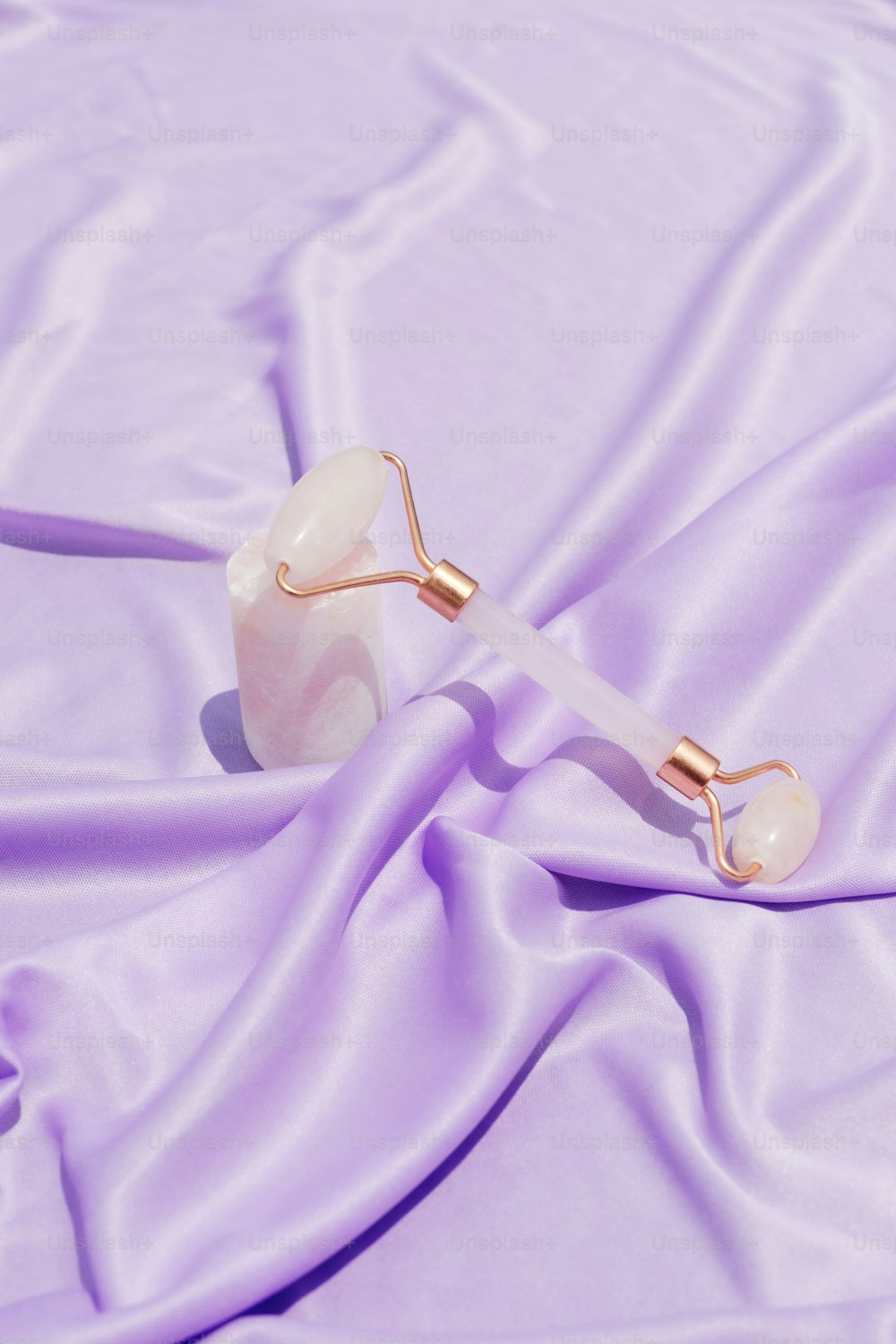 a pair of ear plugs laying on a purple cloth