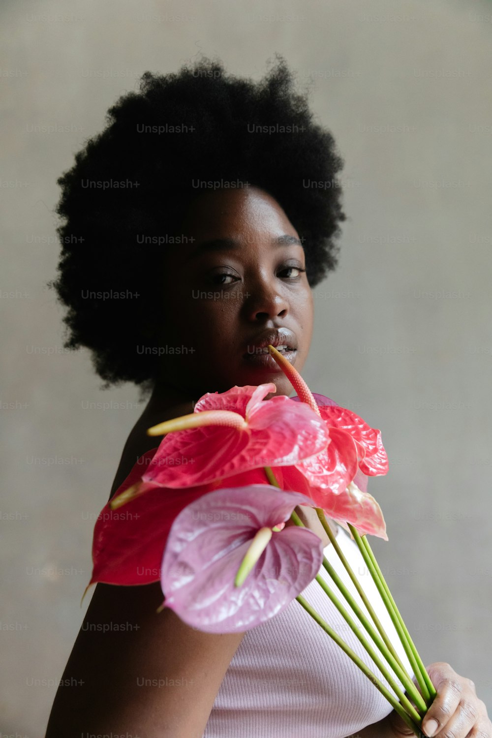 a woman holding a bunch of flowers in her hands