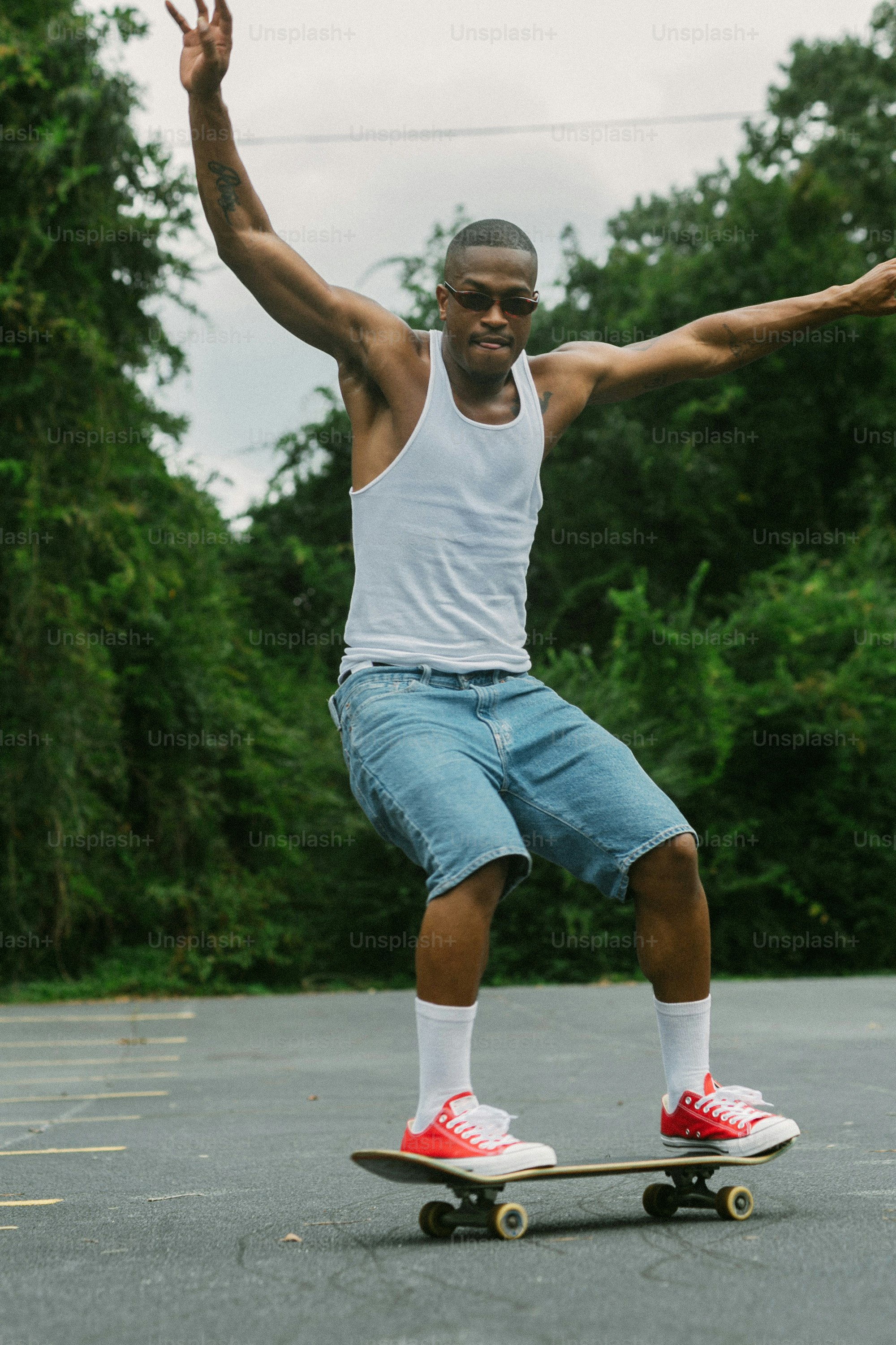 a man riding a skateboard across a parking lot