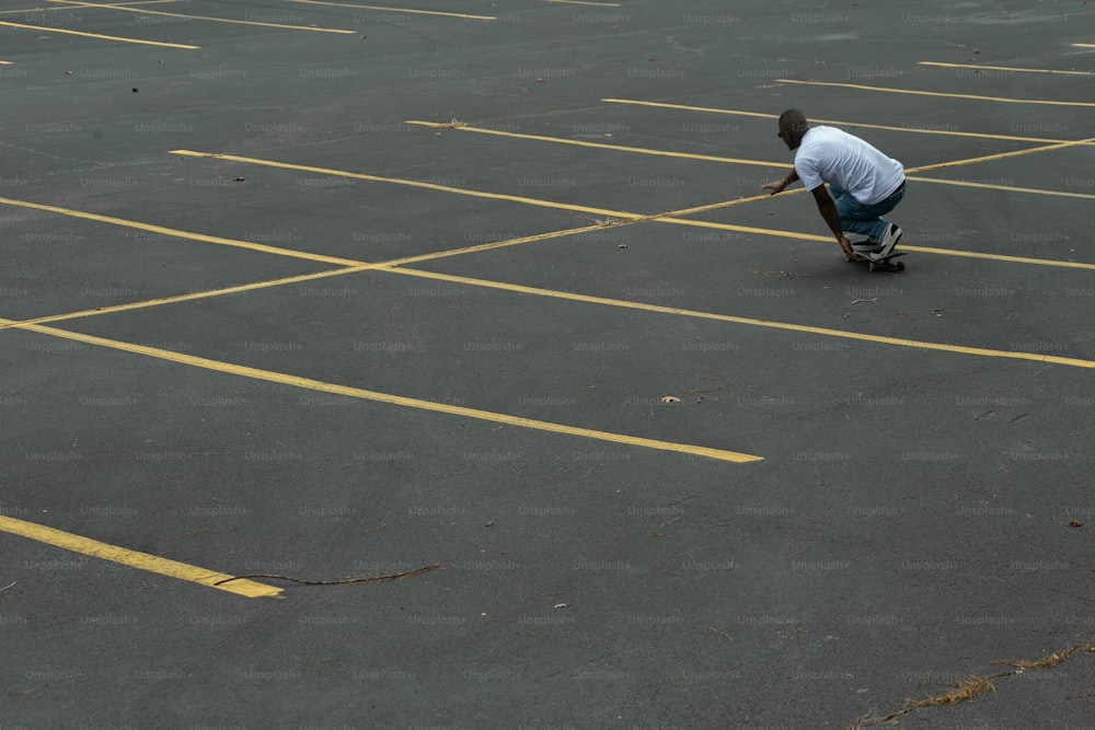 a man riding a skateboard across a parking lot