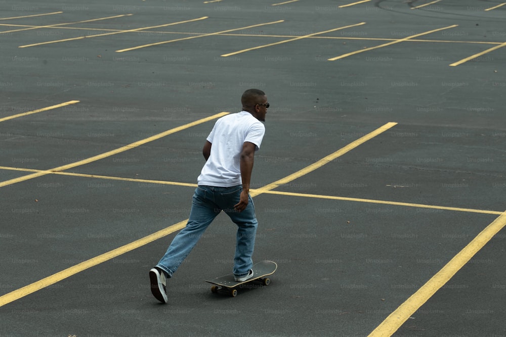 a man riding a skateboard across a parking lot