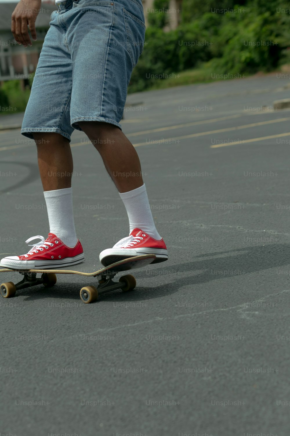a person riding a skateboard in a parking lot