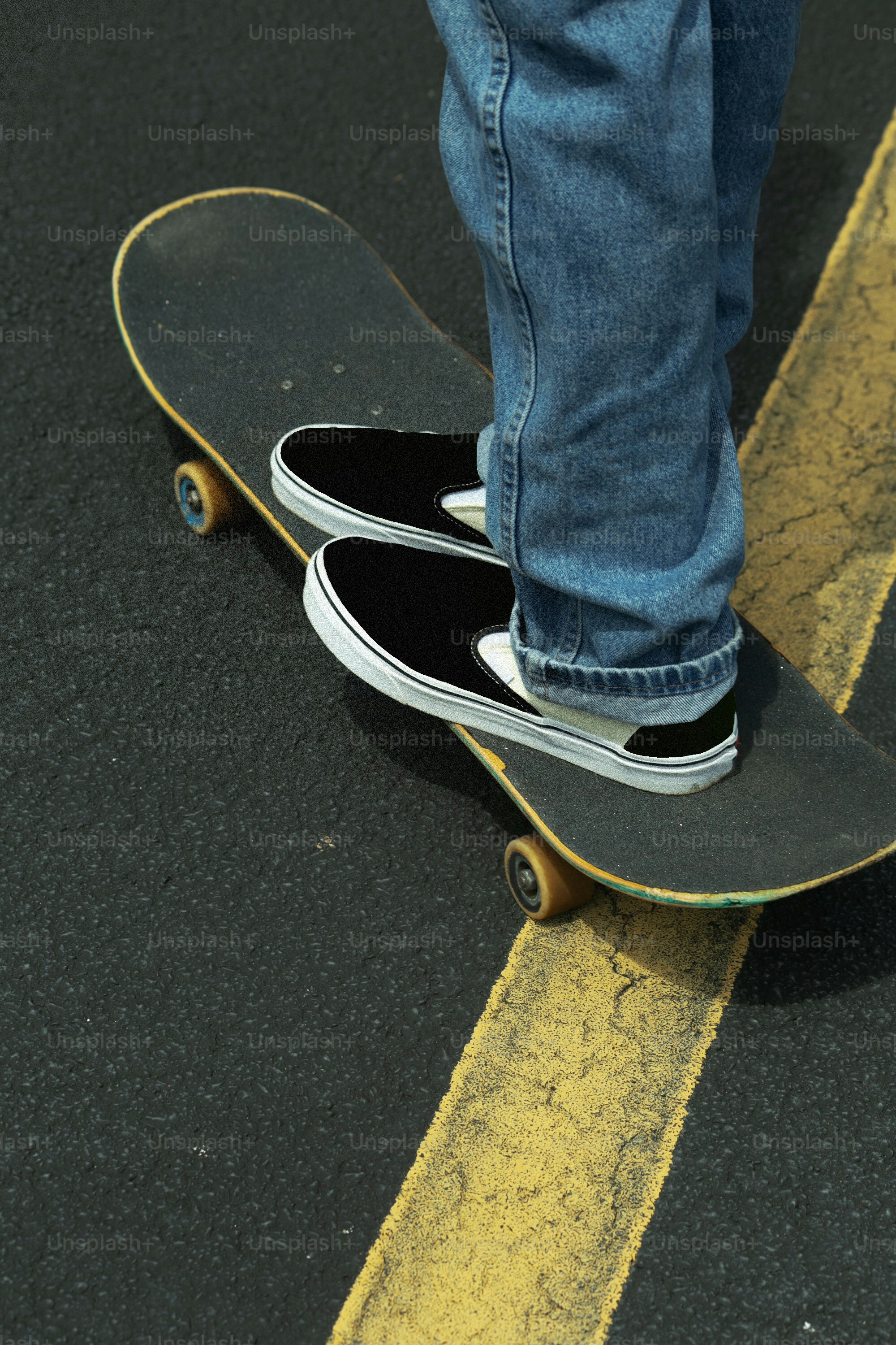 a person standing on a skateboard on a street