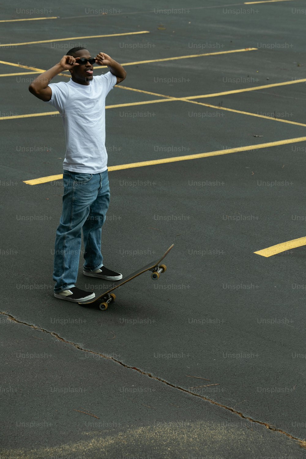 a man riding a skateboard in a parking lot