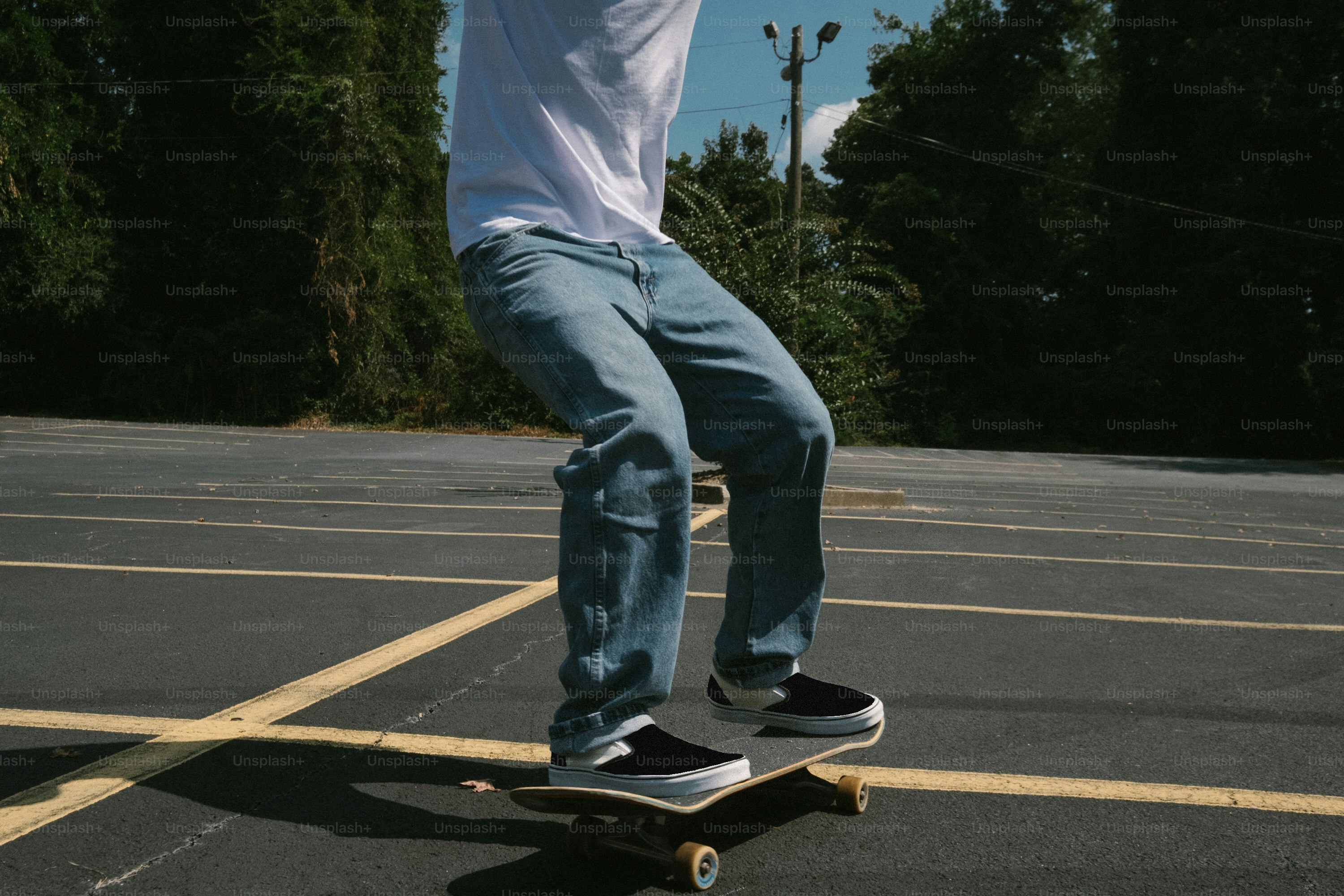 a man riding a skateboard across a parking lot
