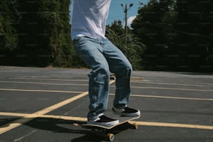 a man riding a skateboard across a parking lot