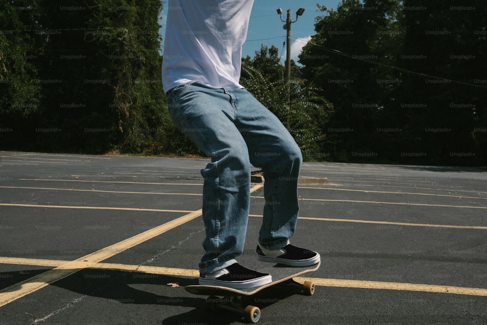 a man riding a skateboard across a parking lot