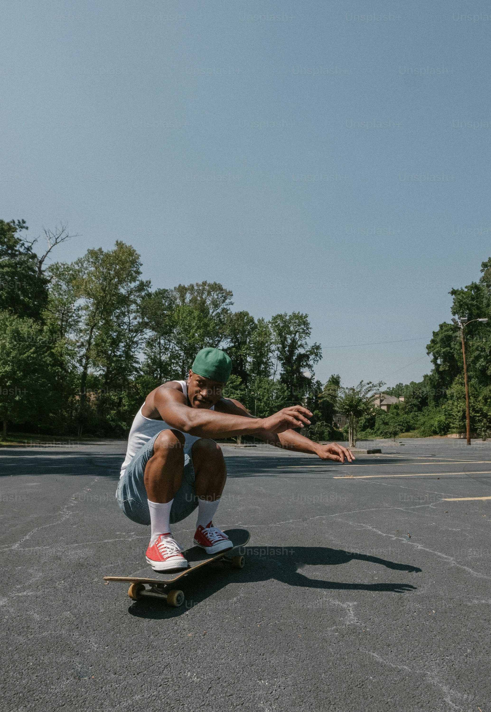 a man riding a skateboard across a parking lot
