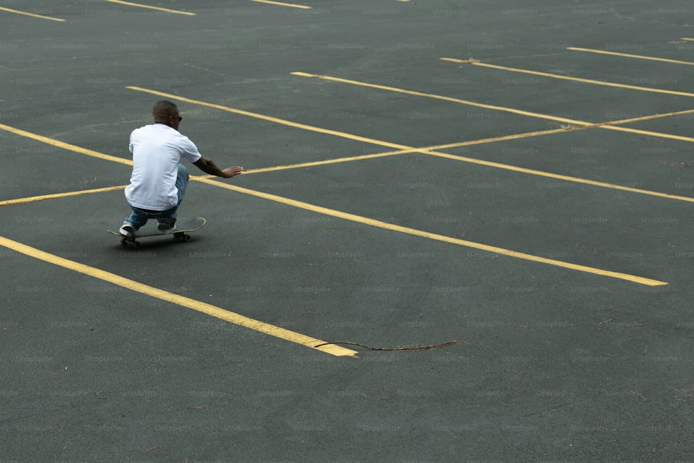 a man riding a skateboard across a parking lot