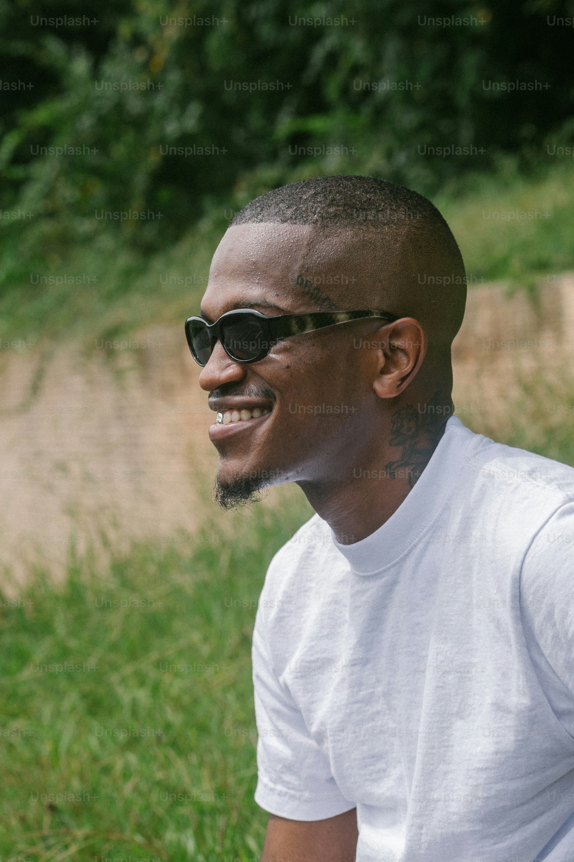 a man wearing sunglasses and a white shirt