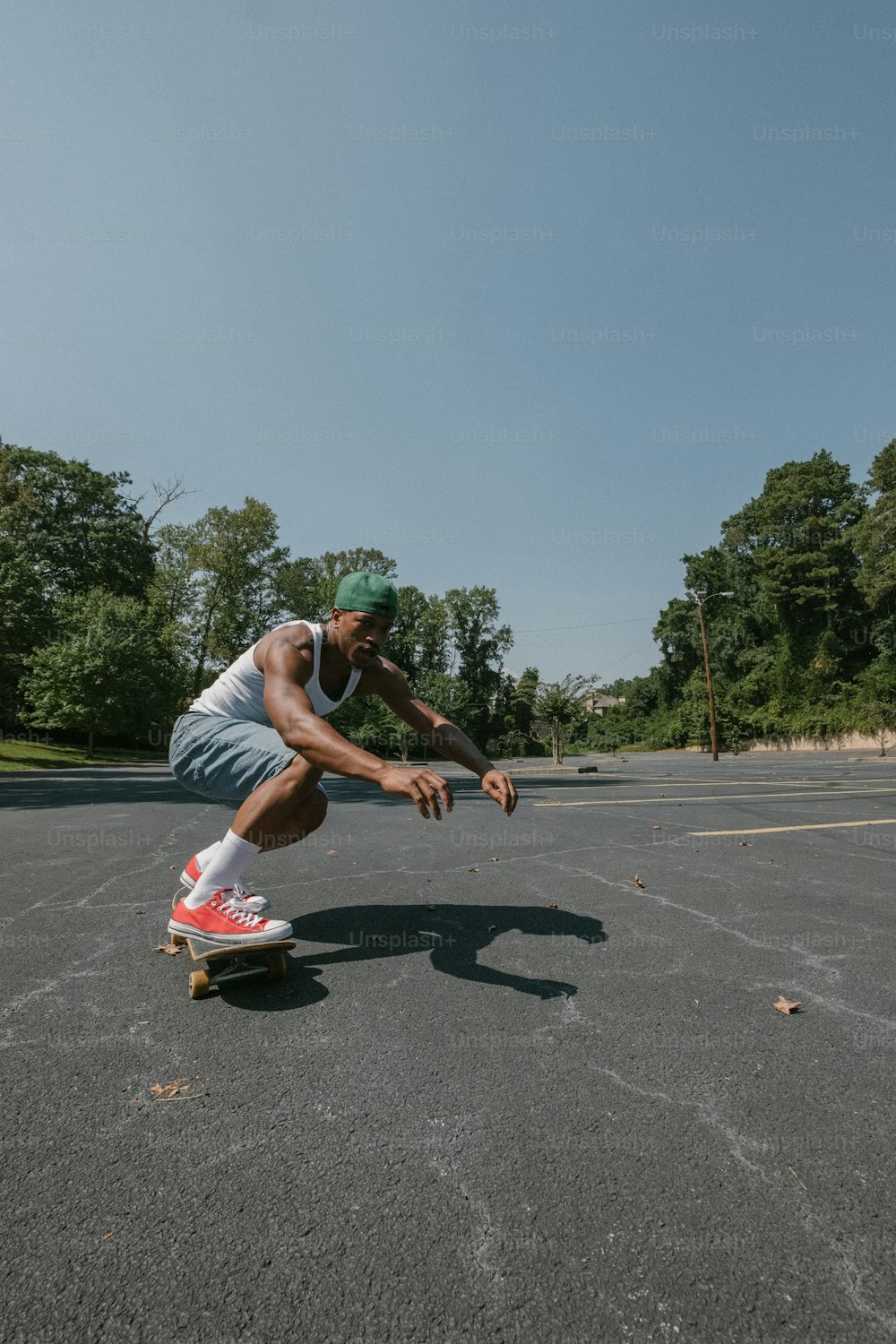 a man riding a skateboard across a parking lot