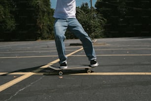 a man riding a skateboard across a parking lot