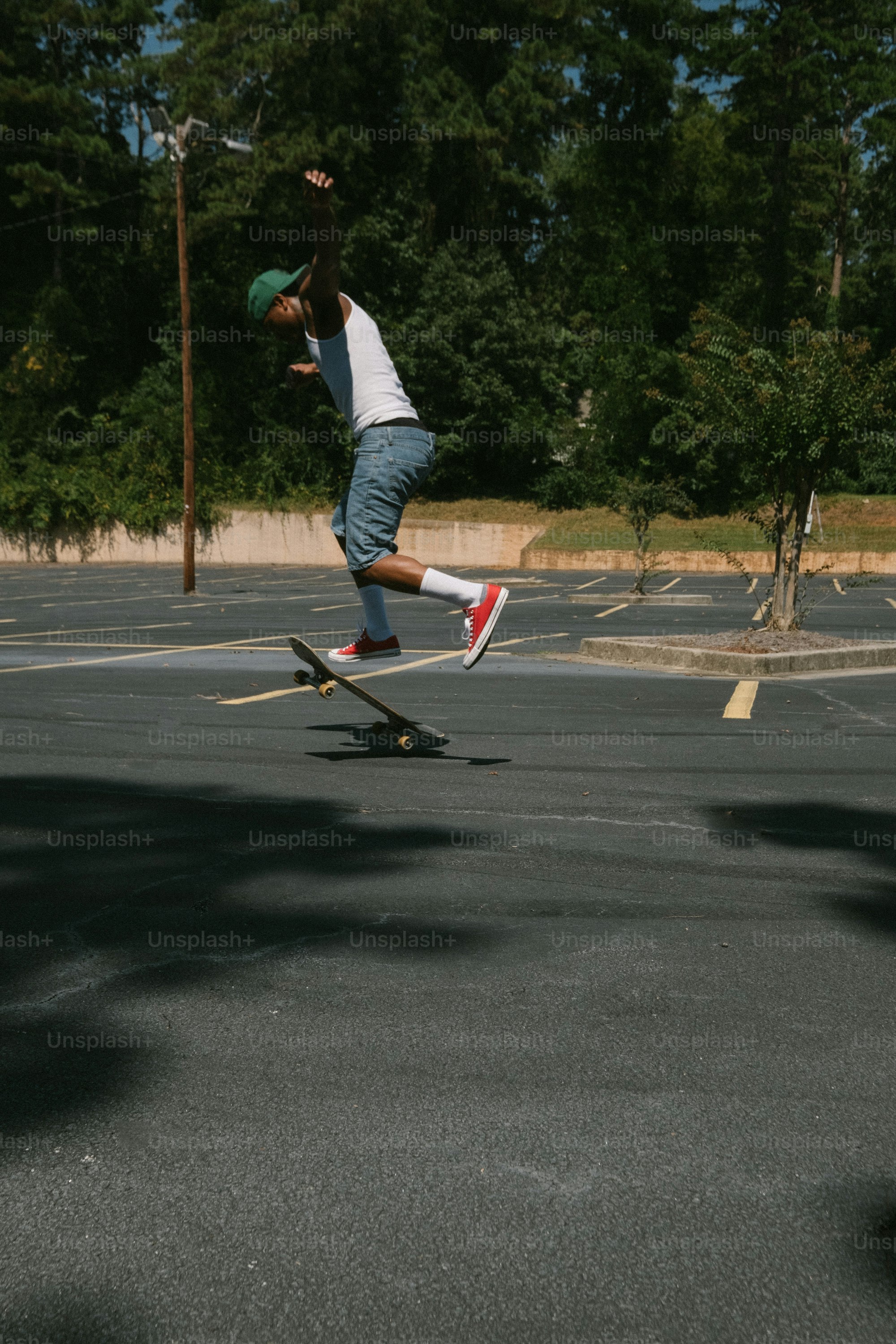 a man riding a skateboard across a parking lot