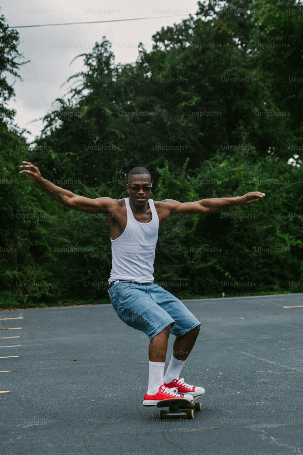 a man riding a skateboard across a parking lot