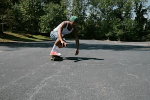 a man riding a skateboard down the middle of a parking lot