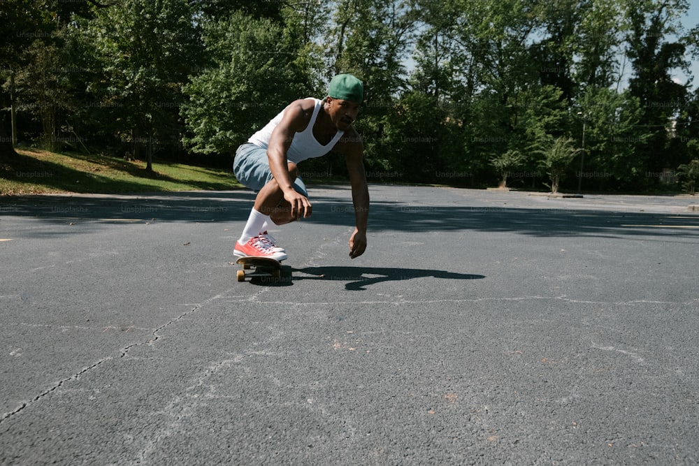 a man riding a skateboard down the middle of a parking lot
