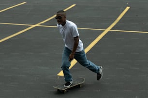 a man riding a skateboard across a parking lot