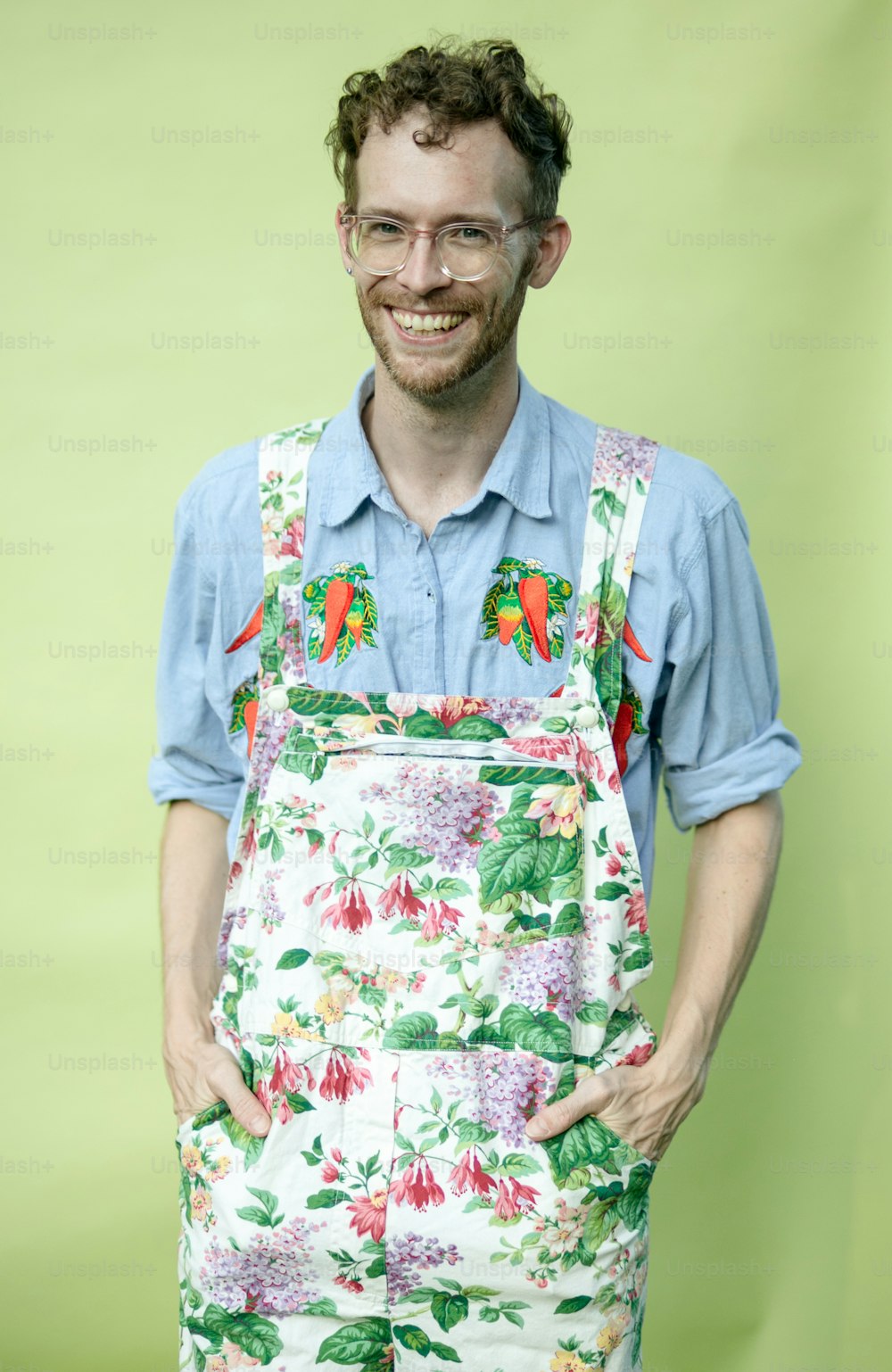 a man with glasses and a flowered apron