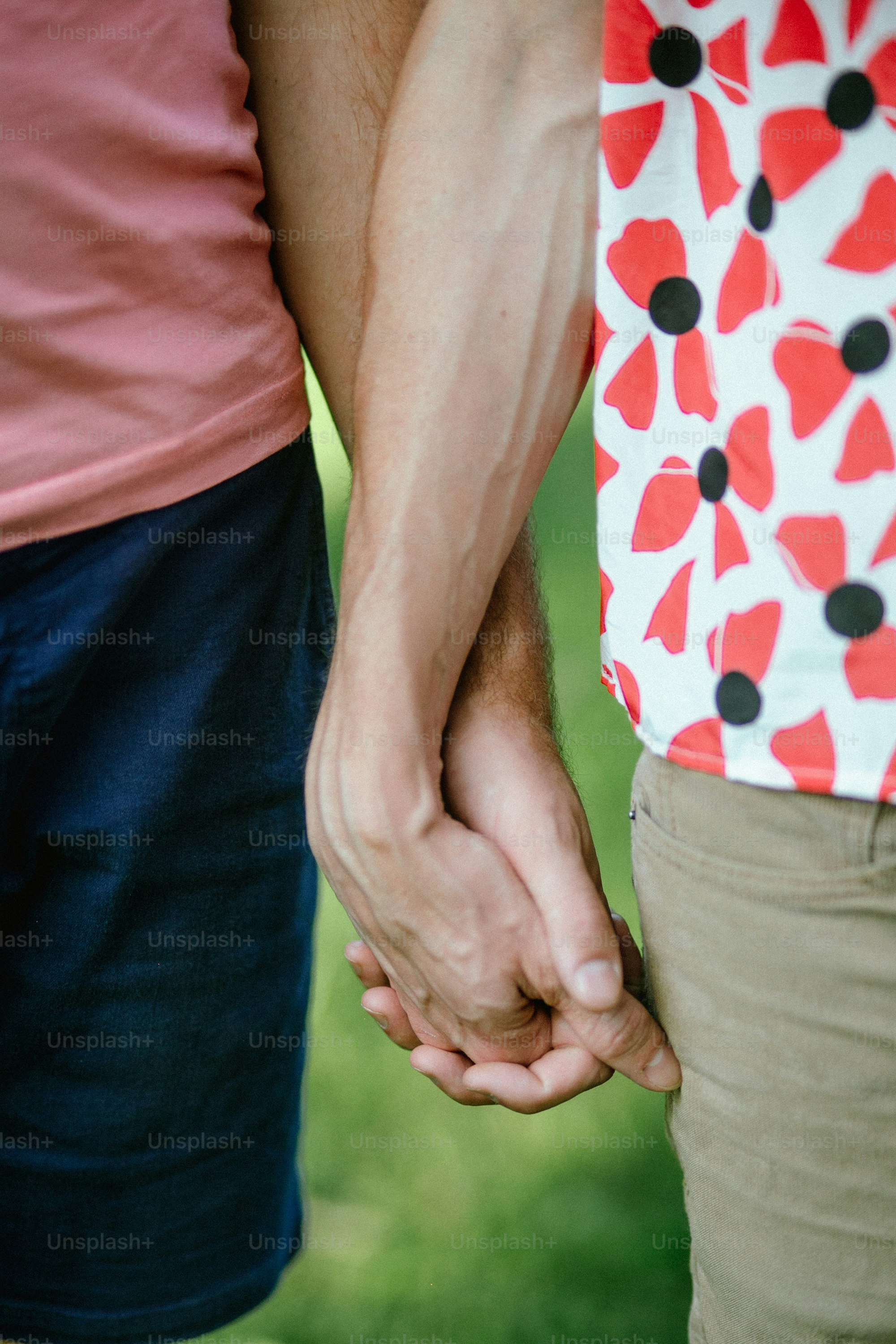 a close up of two people holding hands