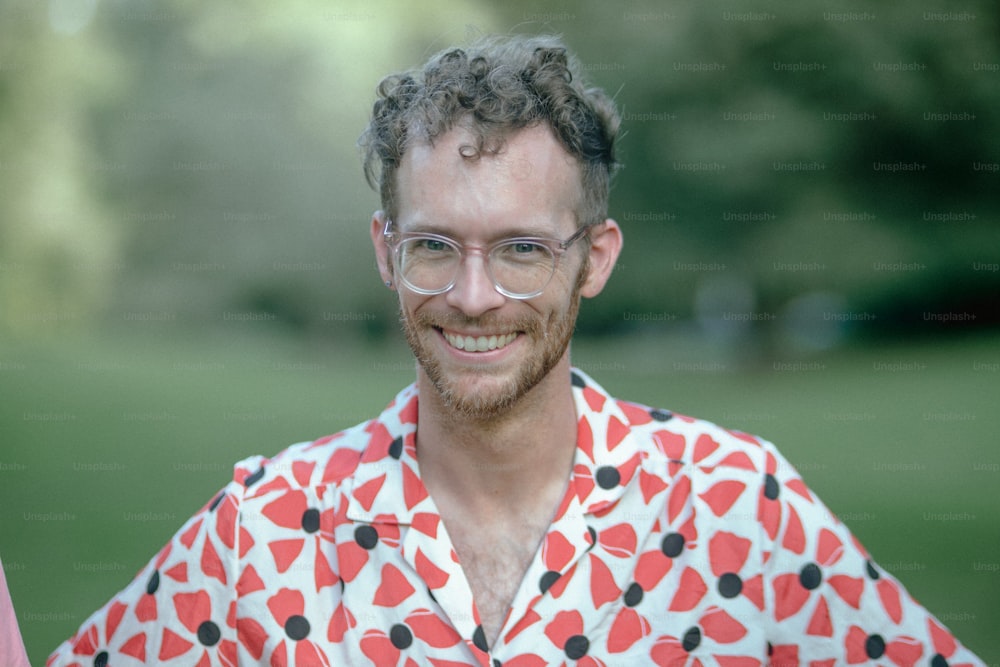 A man with glasses and a red and black shirt photo – Man Image on