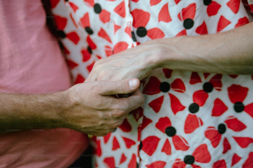 a woman holding a man's hand with both hands