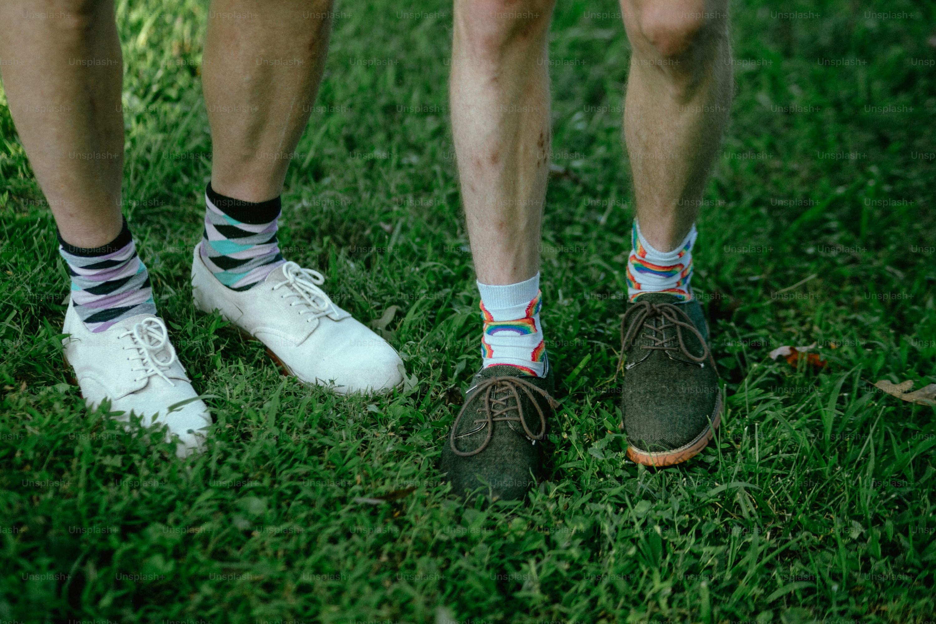 a couple of people standing on top of a lush green field