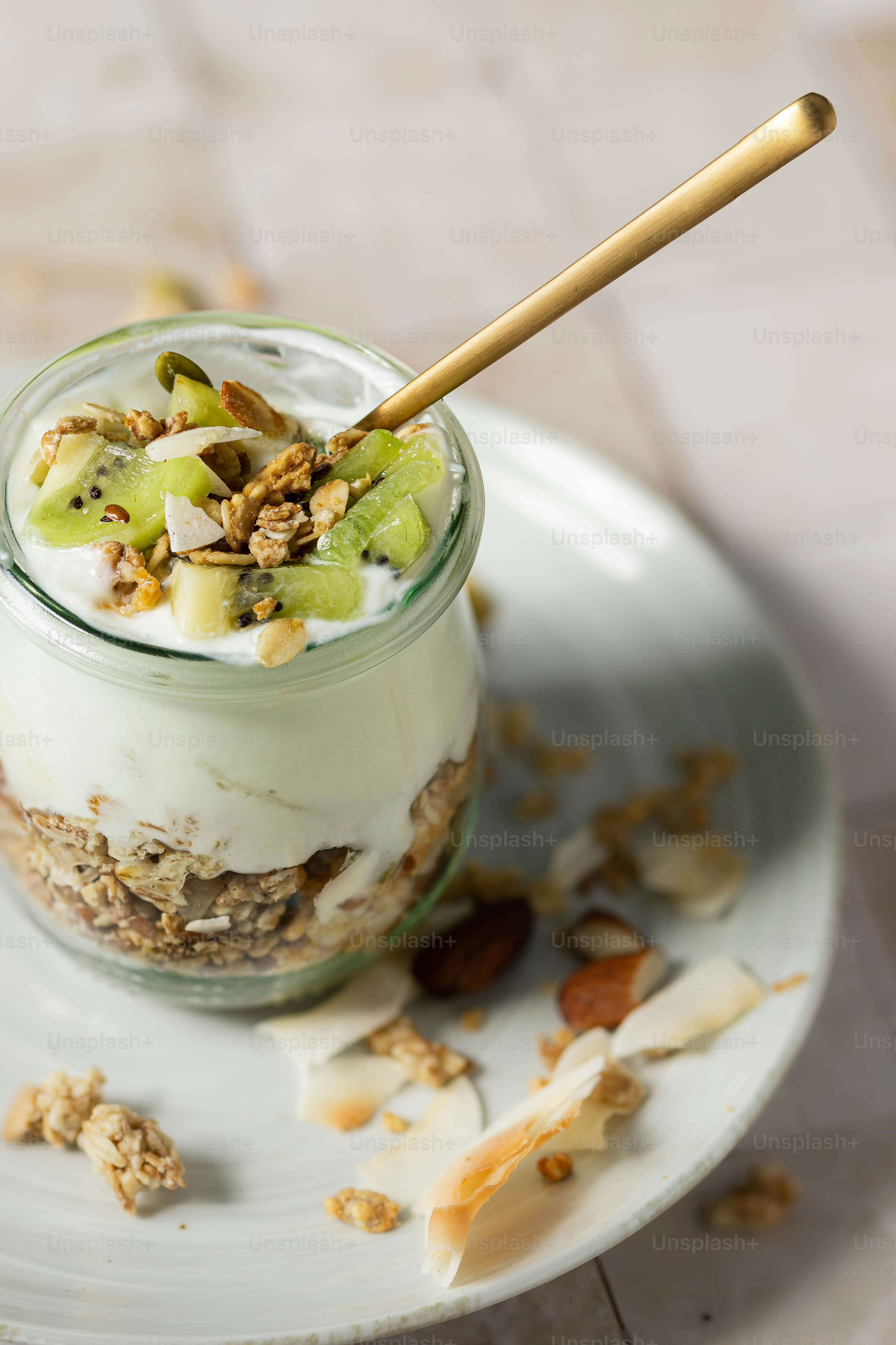 a glass jar filled with granola and fruit